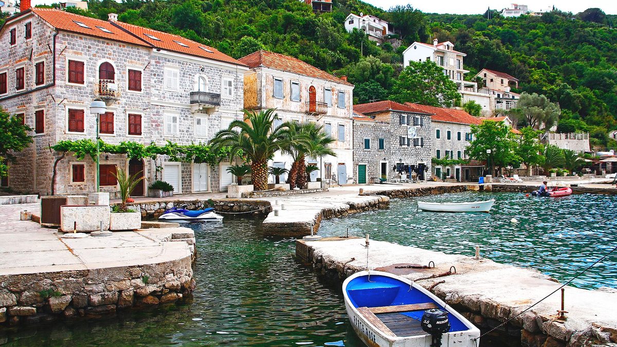 Stone houses and boats in the harbour of Rose on the Luštica peninsula